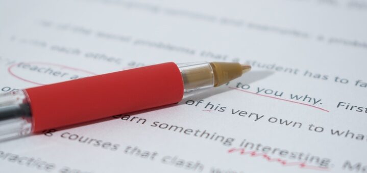 Red pen on paper for proofreading