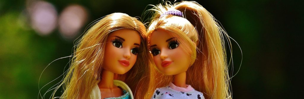 Two dolls are similar but not identical.